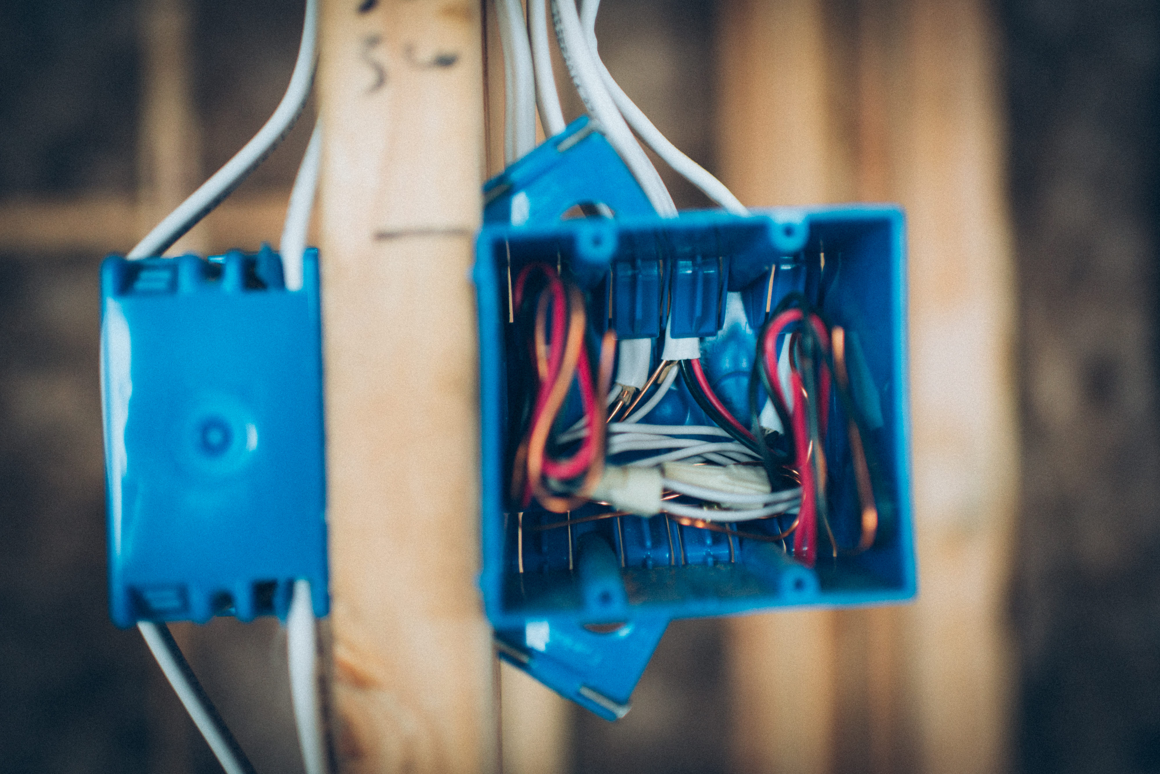 Electricista mostrando errores comunes en una instalación eléctrica durante una revisión oficial de industria, ambiente profesional